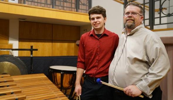 David Walker, left, is director of percussion studies at Old Dominion University. Here, he poses on stage at Chandler Recital Hall with his son Michael, a percussionist and student at ODU.