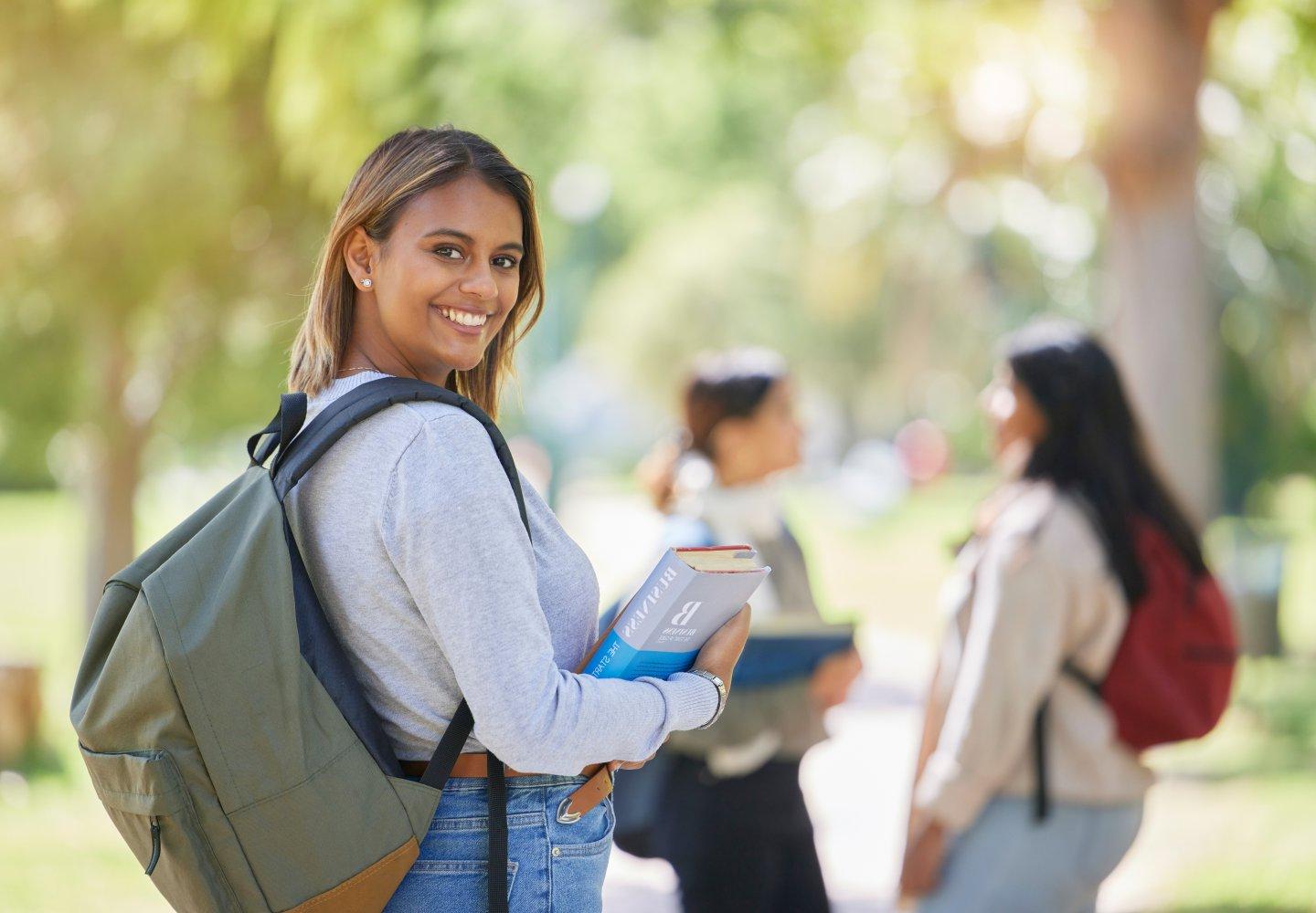 Student with books on campus